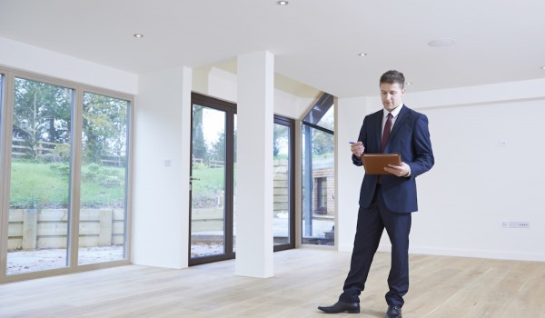 Estate Agent Looking Around Vacant Property For Valuation Estate Agent Looking Around Vacant Property For Valuation